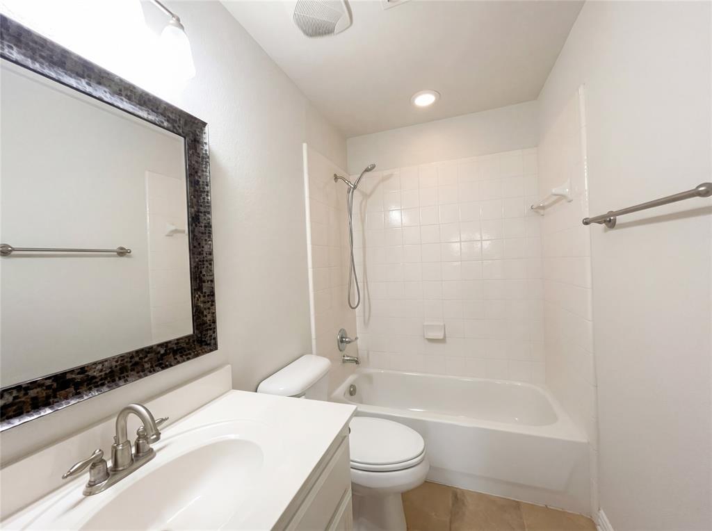 2128 Chambers Drive Allen, TX 75013 - Photo 18 of 23 a bathroom with a bathtub shower sink vanity mirror and toilet