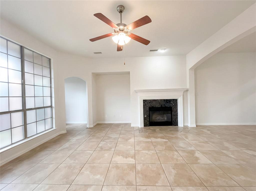 2128 Chambers Drive Allen, TX 75013 - Photo 3 of 23 an empty room with windows and a fireplace