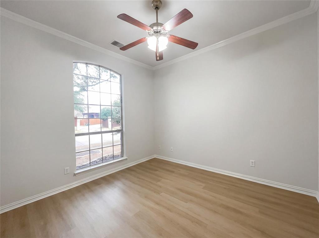 2128 Chambers Drive Allen, TX 75013 - Photo 8 of 23 an empty room with wooden floor chandelier fan and windows