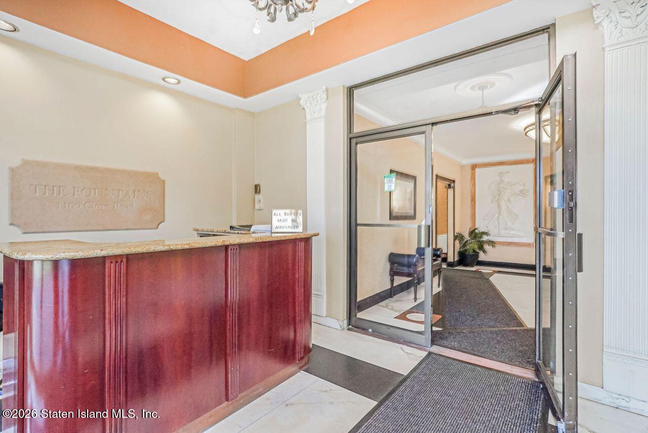 1100 Clove Road, Unit 5G Staten Island, NY 10301 - Photo 2 of 14 a view of a hallway with bathroom and mirror