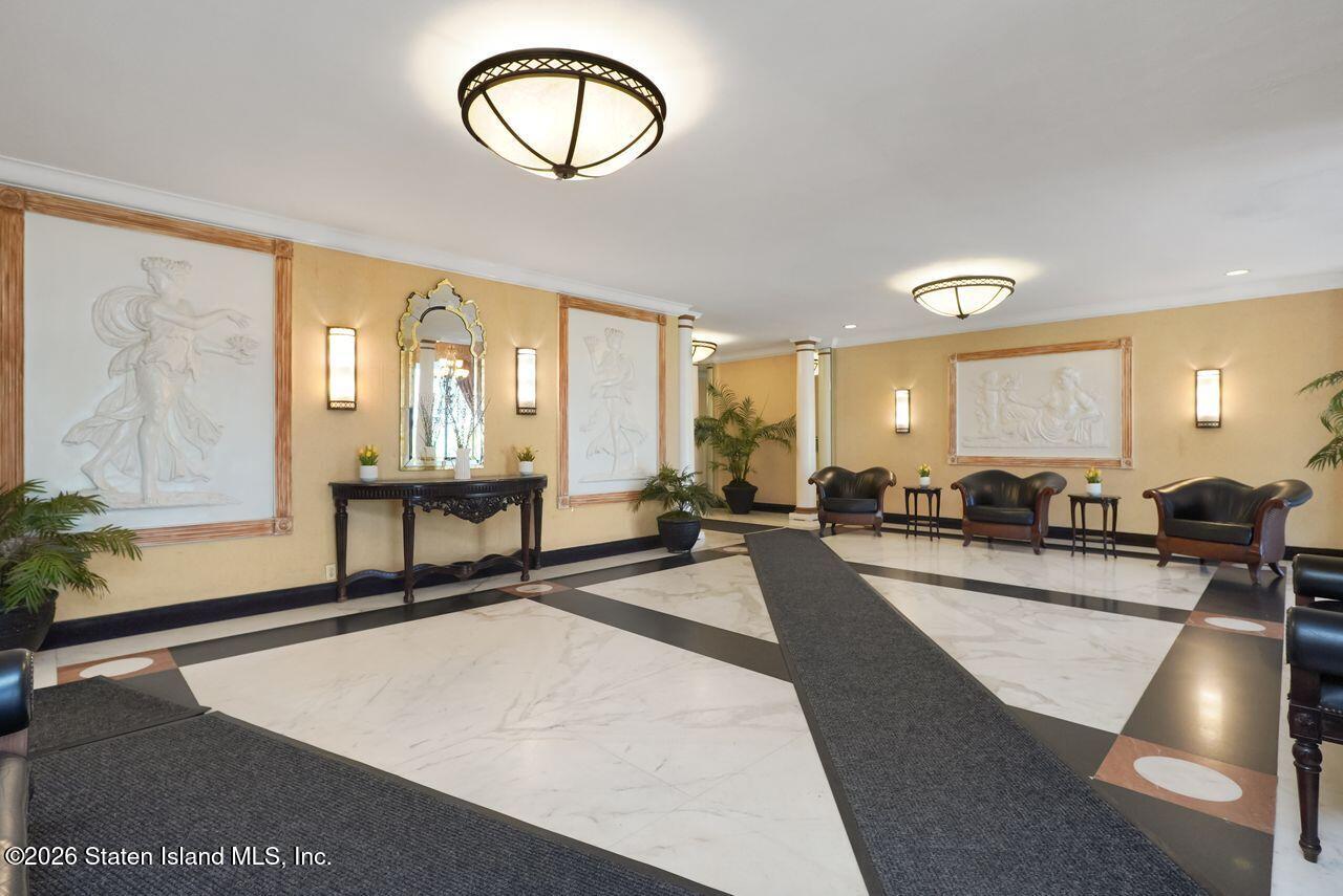 1100 Clove Road, Unit 5G Staten Island, NY 10301 - Photo 3 of 14 a living room with furniture a large window and wooden floor