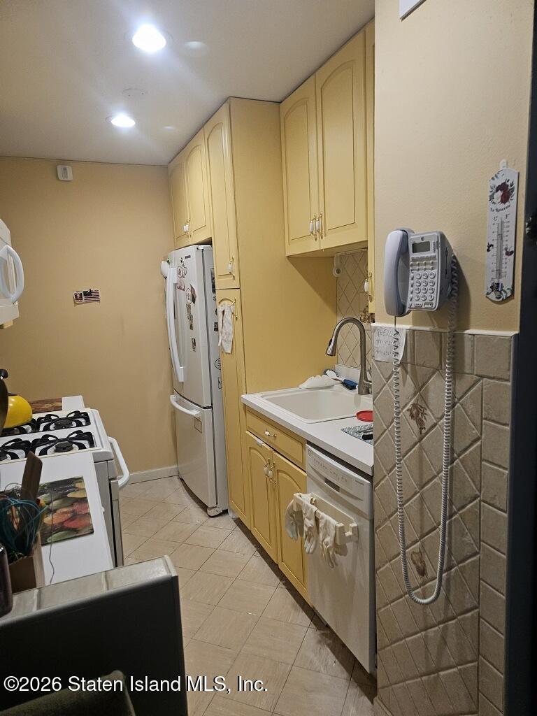 1100 Clove Road, Unit 5G Staten Island, NY 10301 - Photo 5 of 14 a kitchen with stainless steel appliances granite countertop a sink and cabinets