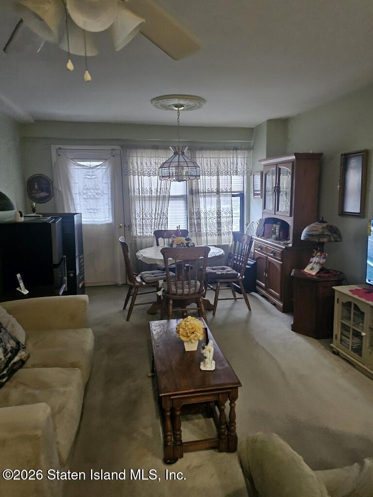1100 Clove Road, Unit 5G Staten Island, NY 10301 - Photo 6 of 14 a living room with furniture large window and flat screen tv