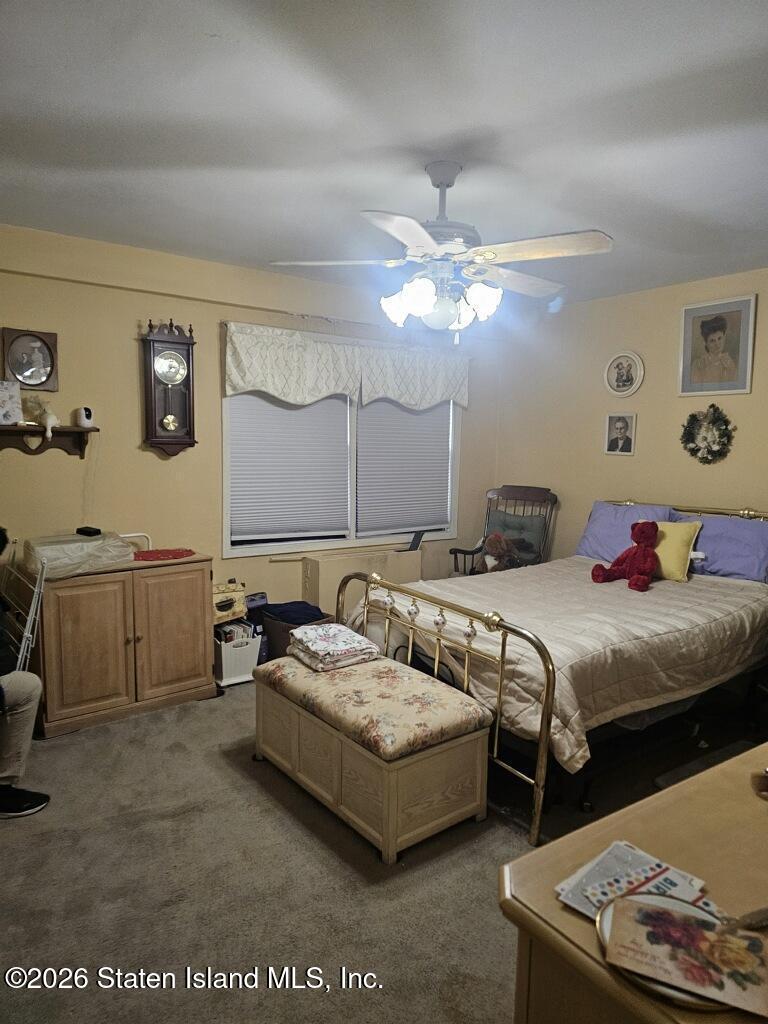 1100 Clove Road, Unit 5G Staten Island, NY 10301 - Photo 7 of 14 a bedroom with a bed a couch and painting on the wall