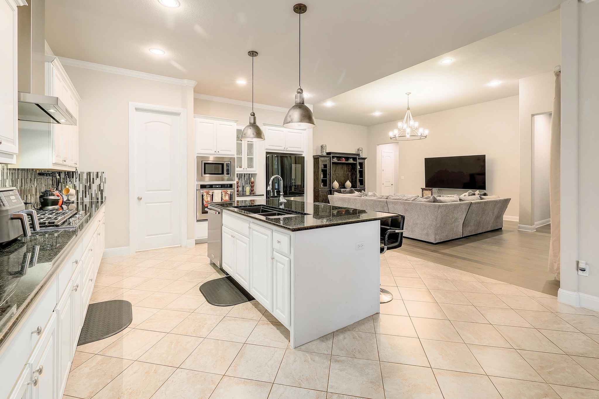 249 Axis Loop Georgetown, TX 78628 - Photo 36 of 36 a large kitchen with stainless steel appliances kitchen island granite countertop a refrigerator a stove top oven and a sink with granite countertops