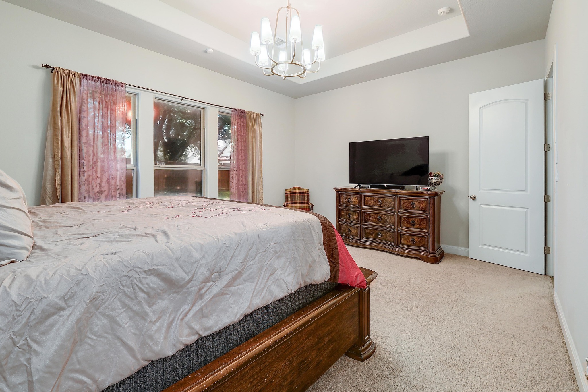 249 Axis Loop Georgetown, TX 78628 - Photo 17 of 36 a spacious bedroom with a bed and a flat screen tv