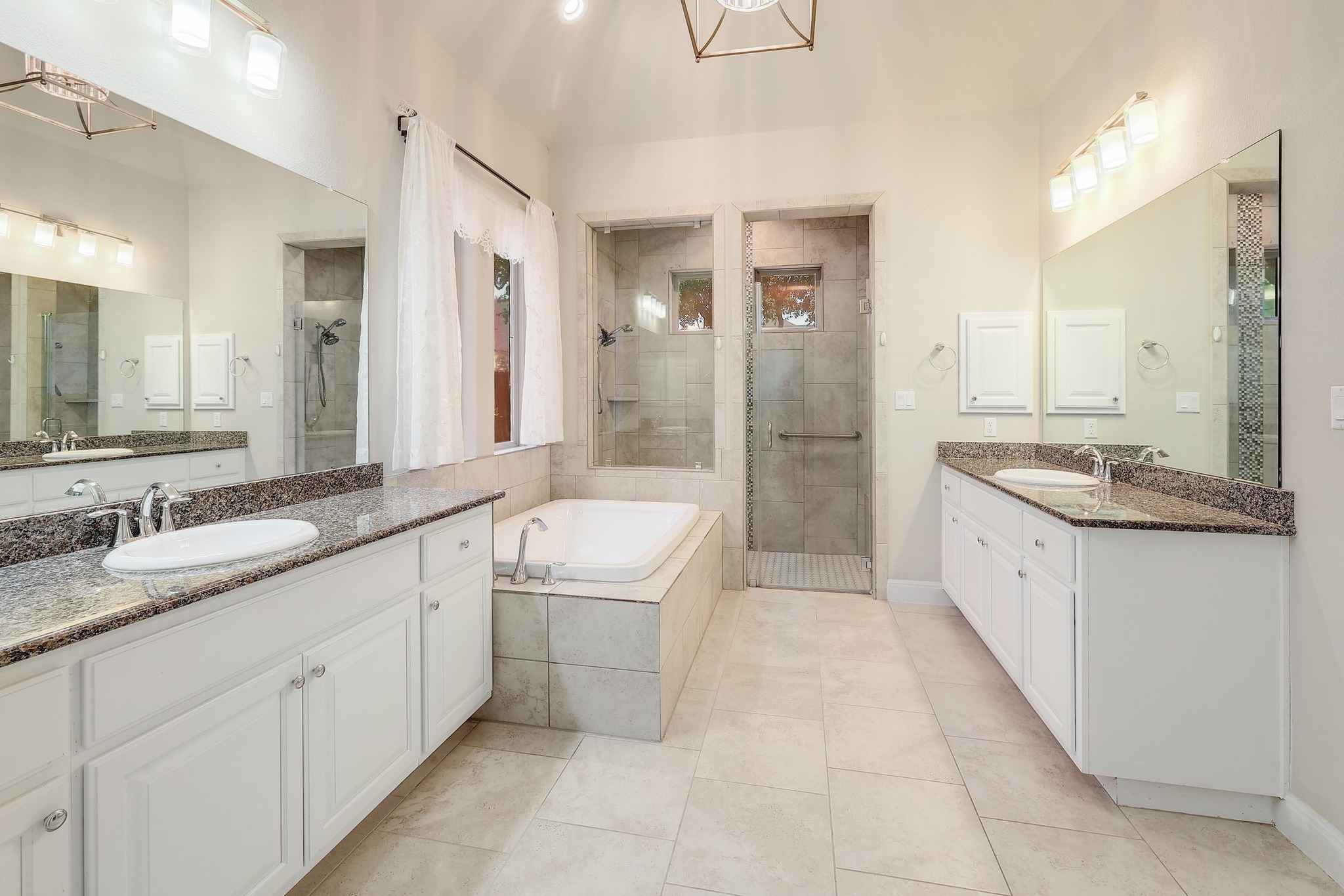249 Axis Loop Georgetown, TX 78628 - Photo 18 of 36 a large bathroom with a granite countertop double vanity sink a mirror and a bathtub