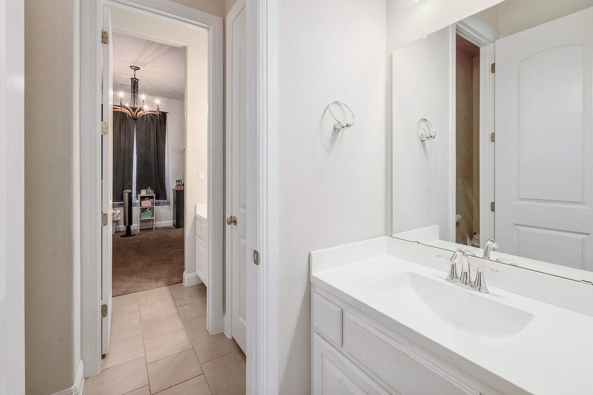 249 Axis Loop Georgetown, TX 78628 - Photo 23 of 36 a en suite bathroom with a sink and mirror