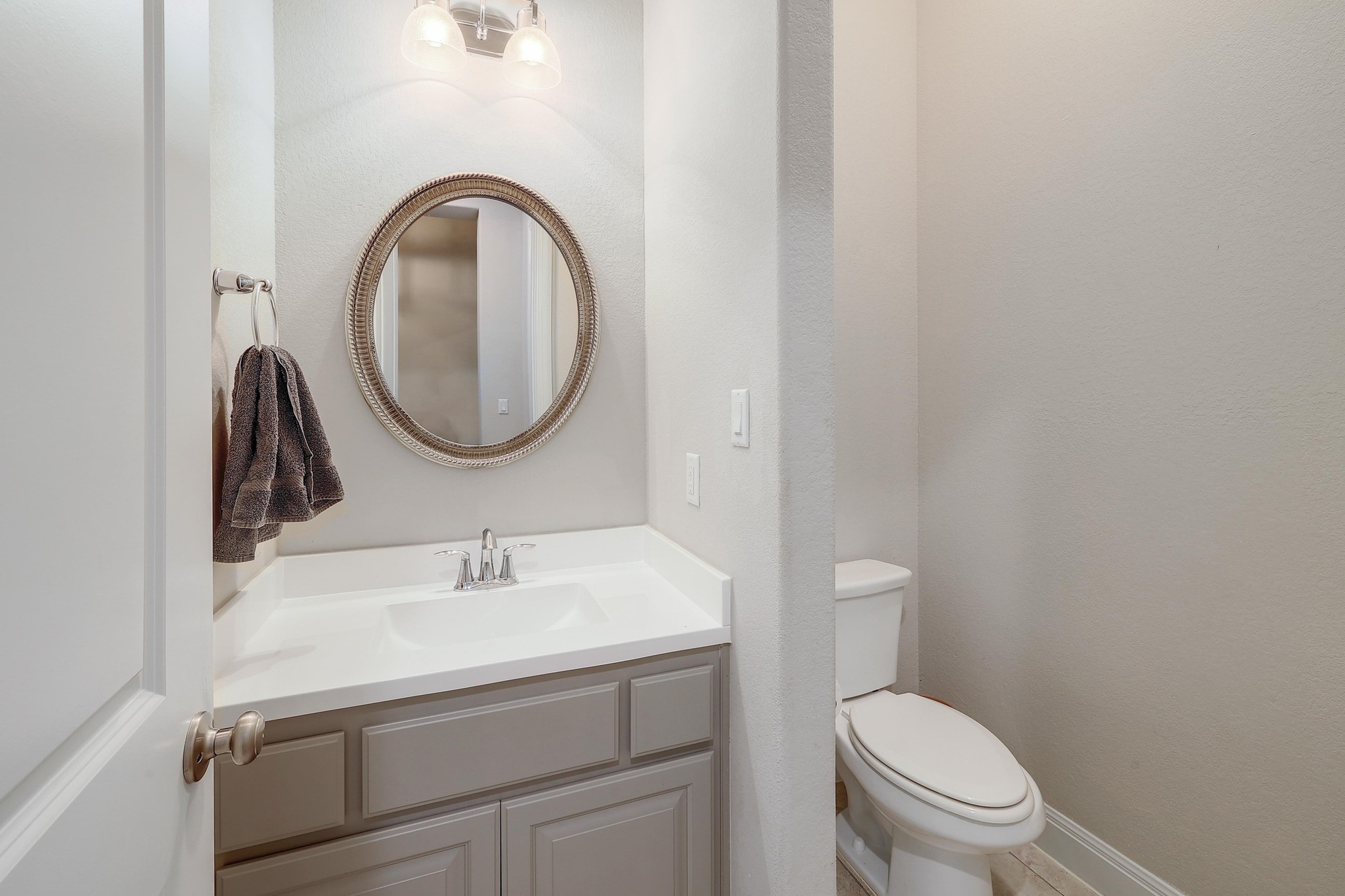 249 Axis Loop Georgetown, TX 78628 - Photo 27 of 36 a bathroom with a toilet a sink and a mirror