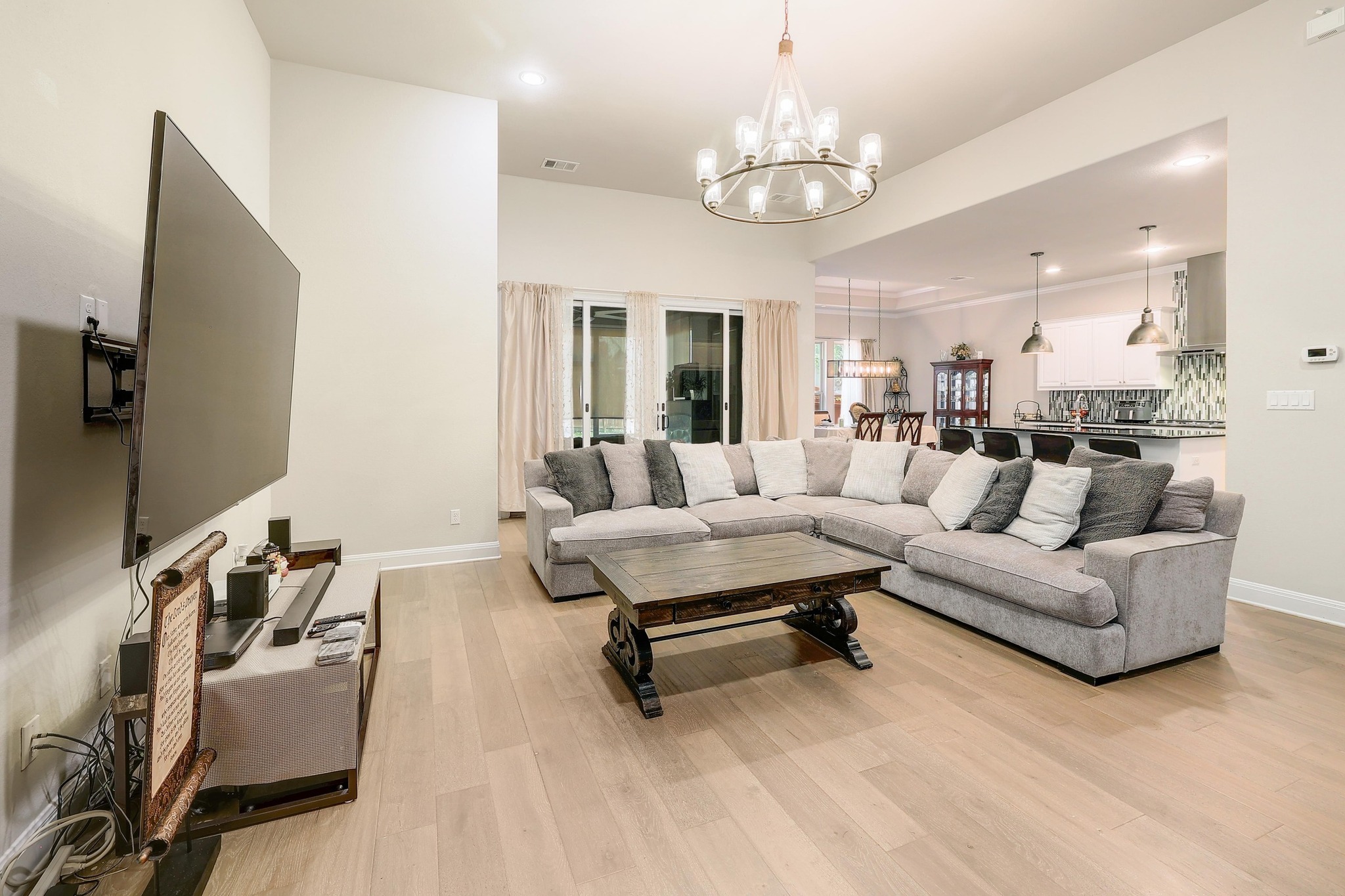 249 Axis Loop Georgetown, TX 78628 - Photo 4 of 36 a living room with furniture chandelier and a flat screen tv