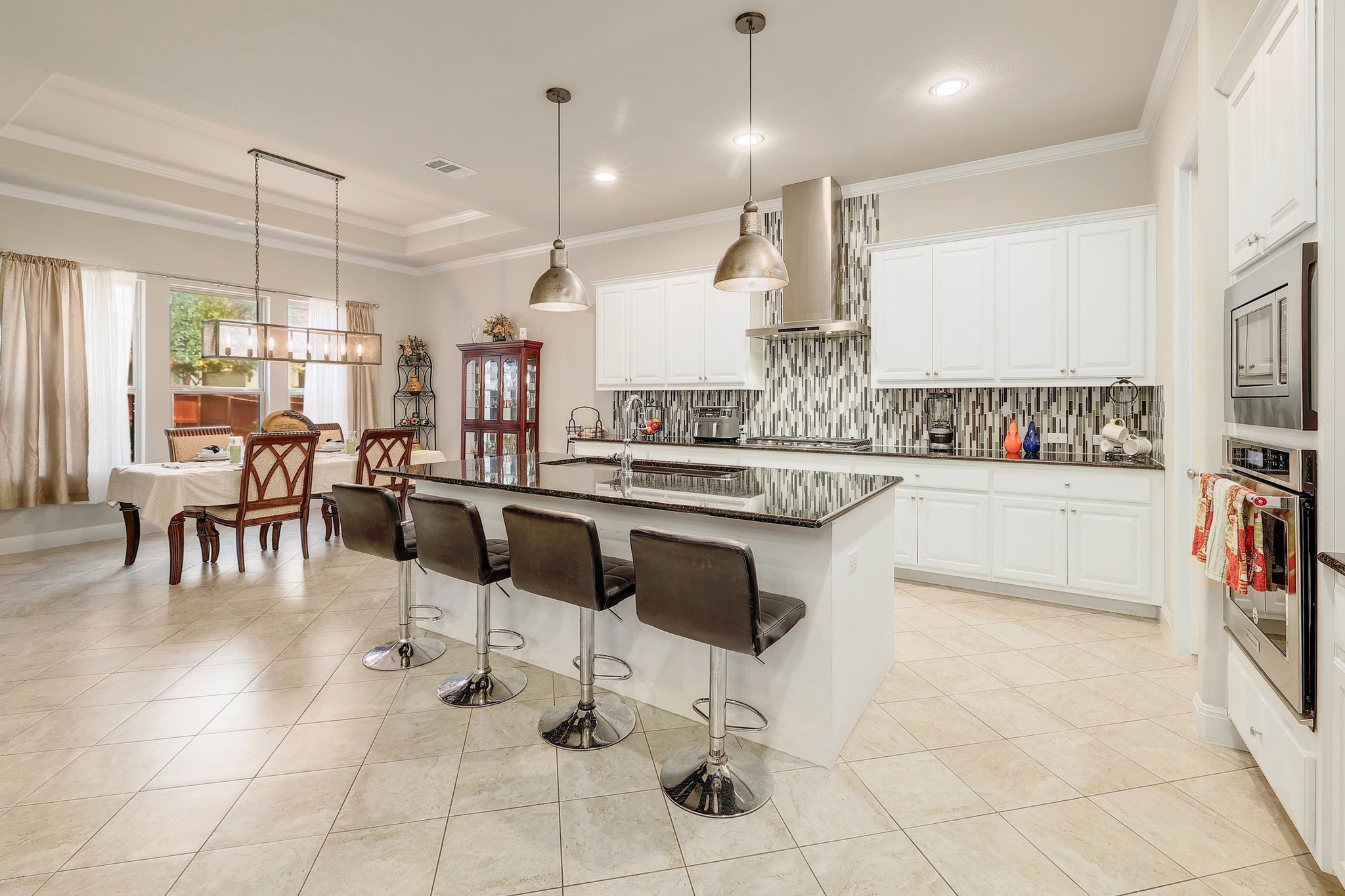 249 Axis Loop Georgetown, TX 78628 - Photo 10 of 36 a kitchen with stainless steel appliances kitchen island granite countertop a sink and cabinets