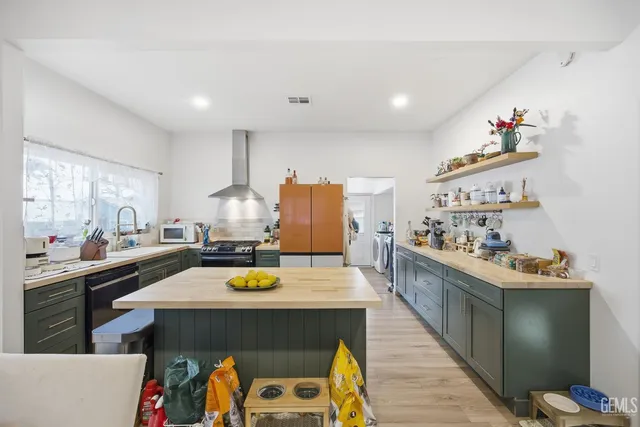 a kitchen with a sink appliances and cabinets