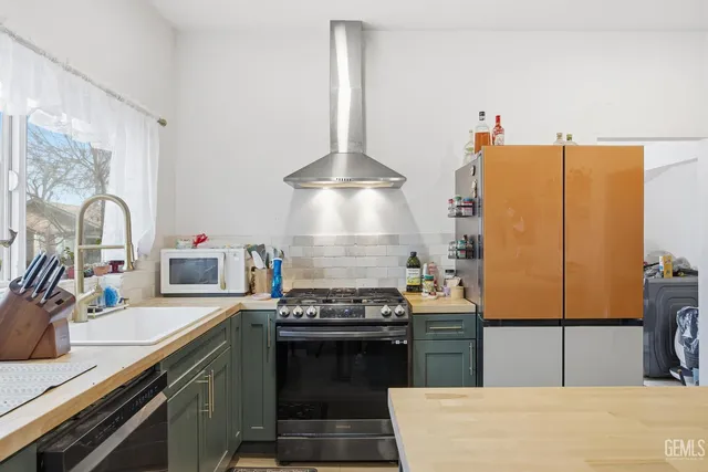 a kitchen with stainless steel appliances granite countertop a stove and a sink