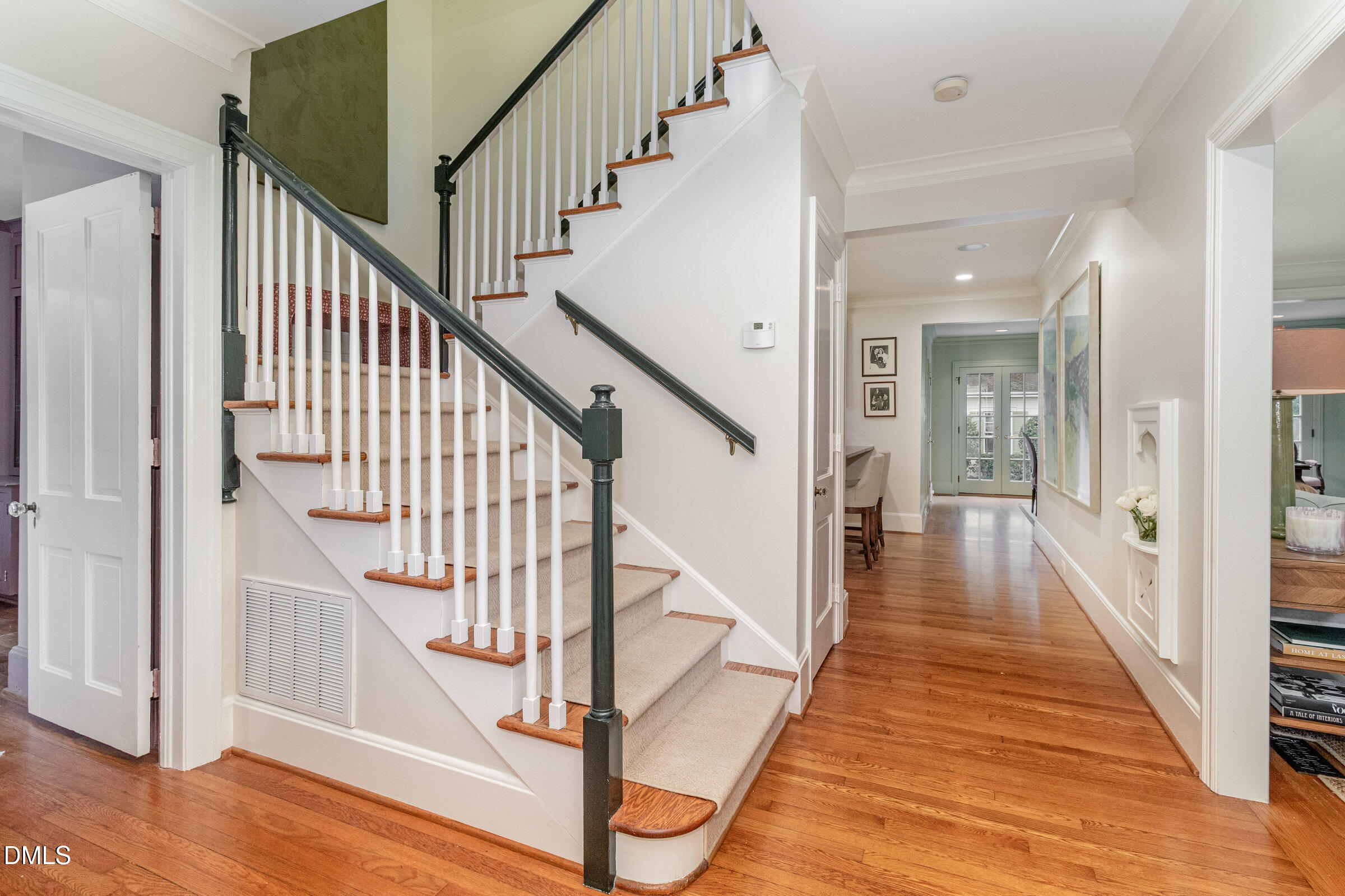 2404 Beechridge Road Raleigh, NC 27608 - Photo 8 of 52 a view of staircase with wooden floor and a chandelier
