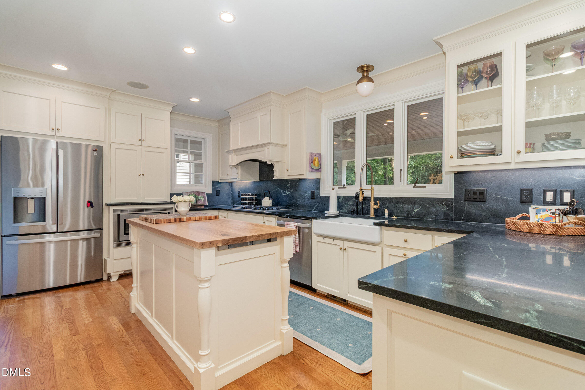 2404 Beechridge Road Raleigh, NC 27608 - Photo 17 of 52 a kitchen with a stove sink and refrigerator