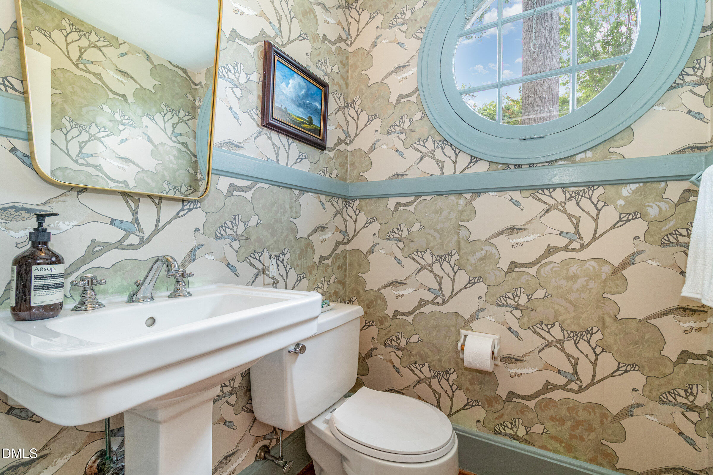 2404 Beechridge Road Raleigh, NC 27608 - Photo 21 of 52 a bathroom with a toilet a sink and a mirror