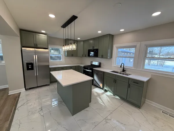 a large bathroom with a sink a large mirror and a shower