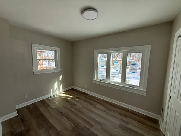 wooden floor in an empty room with a window