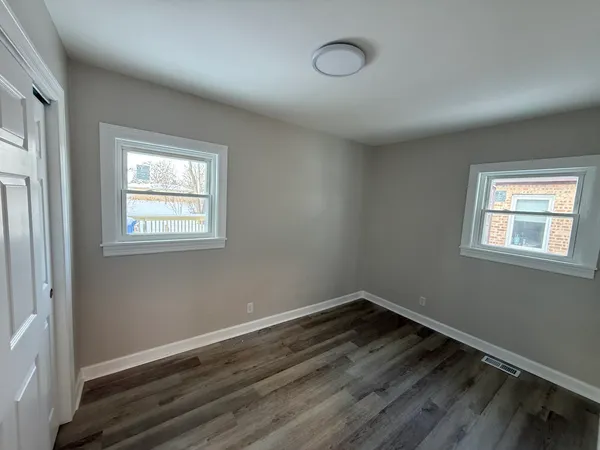 a bathroom with a double vanity sink toilet mirror and bathtub