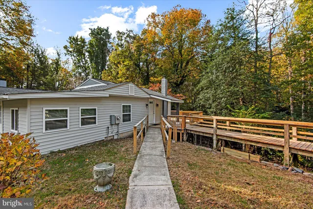 a view of a house with a backyard and a patio