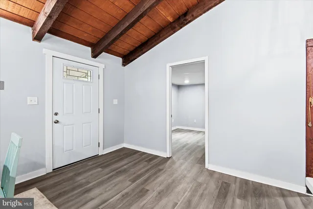 a view of hallway with wooden floor