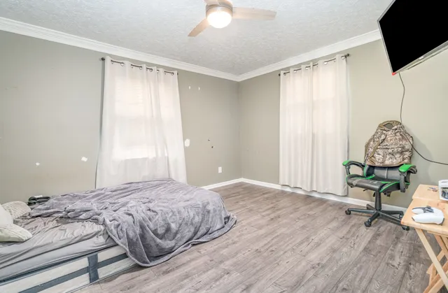 a bedroom with a bed and a window