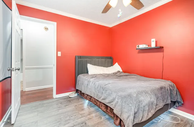 a bedroom with a bed and a potted plant