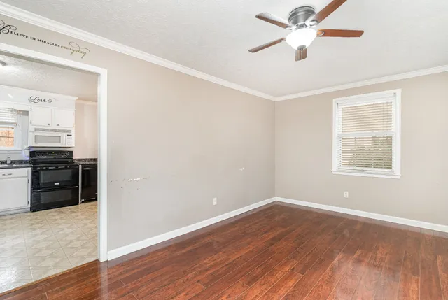 wooden floor in an empty room with a window