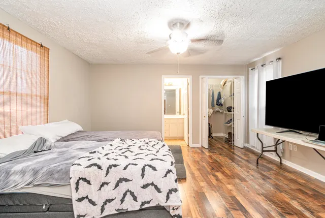 a bedroom with a bed and a flat screen tv