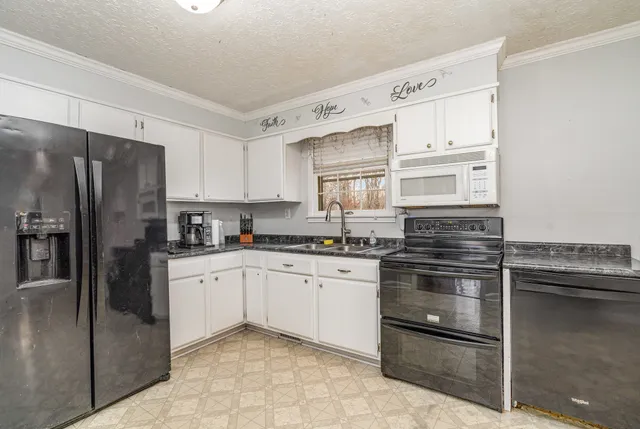 a kitchen with granite countertop stainless steel appliances and cabinets