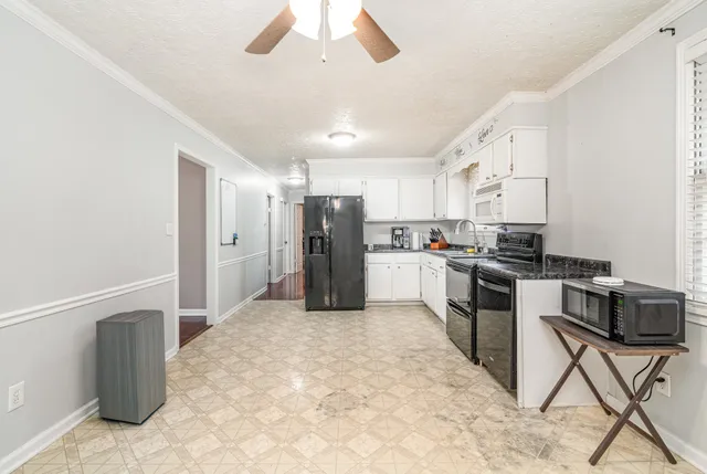 a kitchen with stainless steel appliances kitchen island granite countertop a refrigerator and a stove top oven