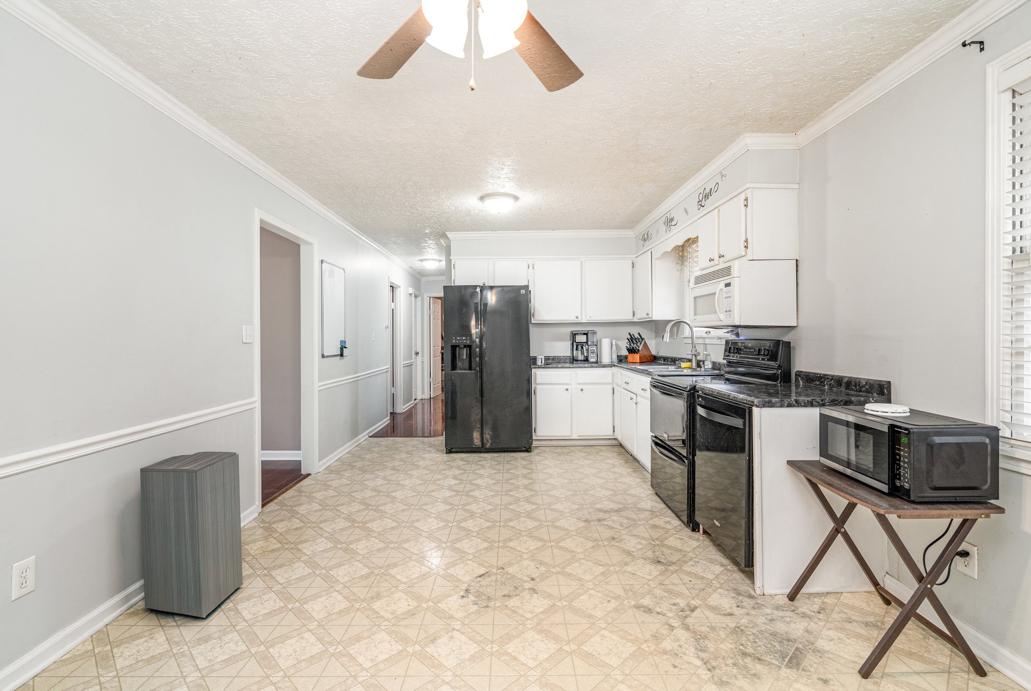 1176 Petty Road White Bluff, TN 37187 - Photo 8 of 23 a kitchen with stainless steel appliances kitchen island granite countertop a refrigerator and a stove top oven