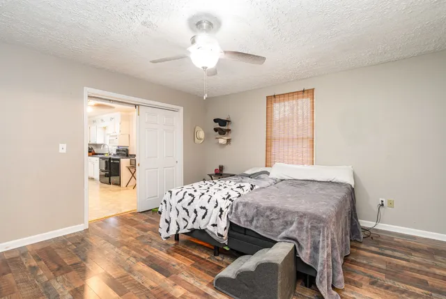 a bedroom with a bed and a chandelier