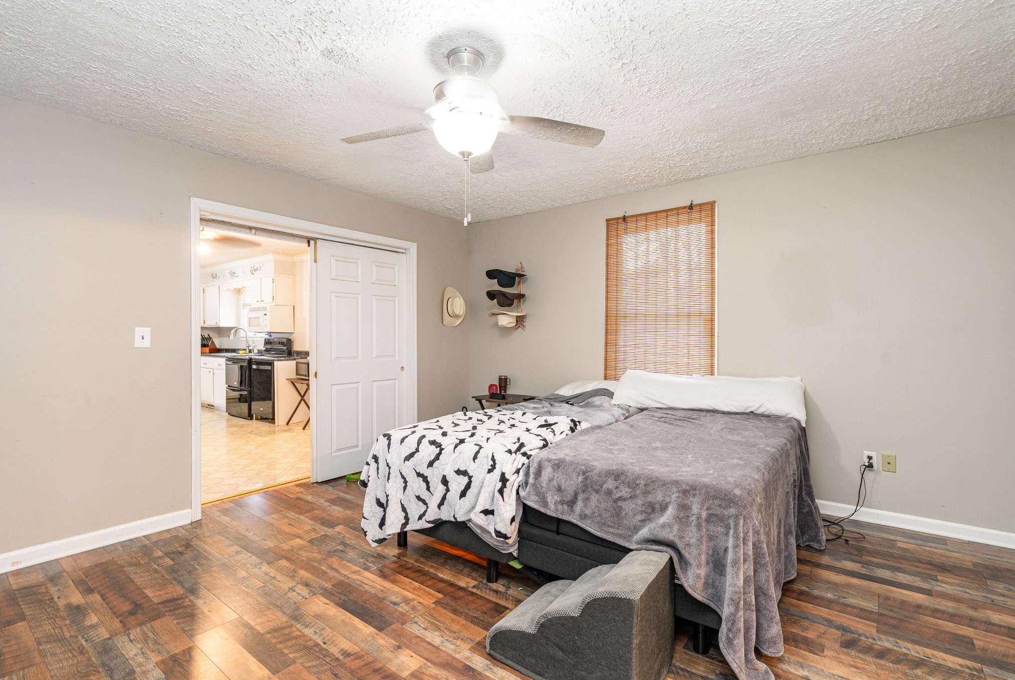 1176 Petty Road White Bluff, TN 37187 - Photo 10 of 23 a bedroom with a bed and a chandelier