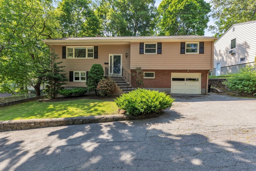 a front view of a house with a yard and a garage