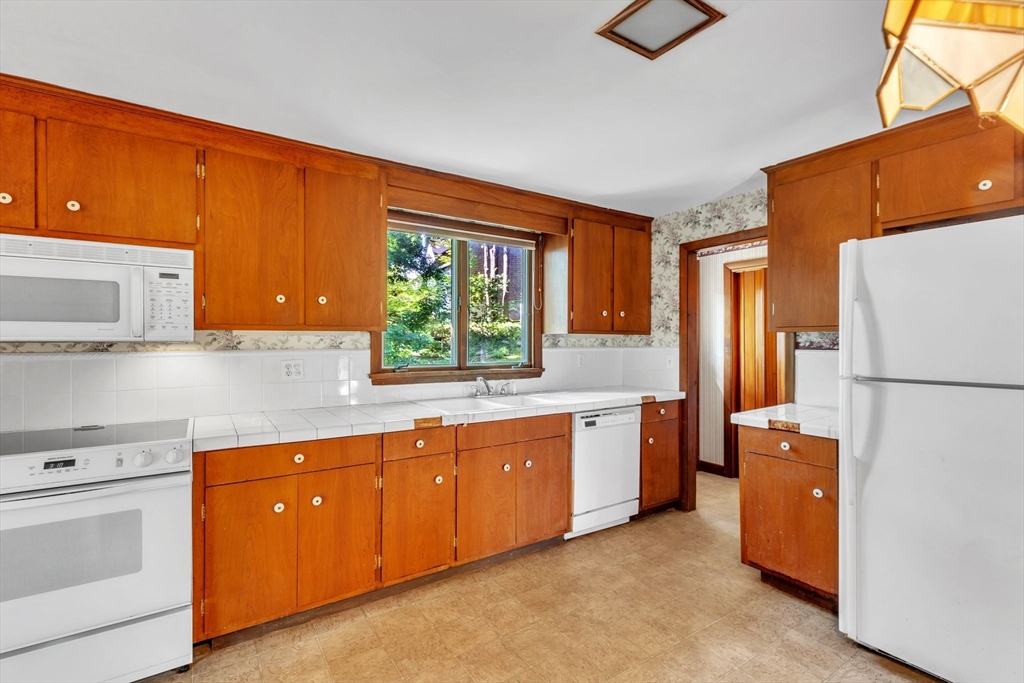 4 Birch Road Swampscott, MA 01907 - Photo 15 of 42 a kitchen with a refrigerator sink and stove top oven