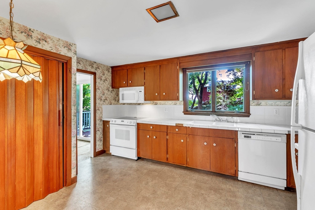 4 Birch Road Swampscott, MA 01907 - Photo 16 of 42 a kitchen with stainless steel appliances granite countertop a refrigerator and a sink