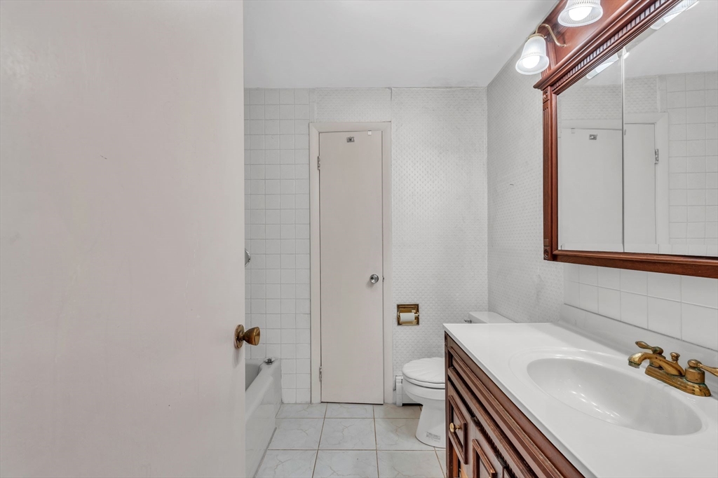 4 Birch Road Swampscott, MA 01907 - Photo 21 of 42 a bathroom with a sink and a mirror