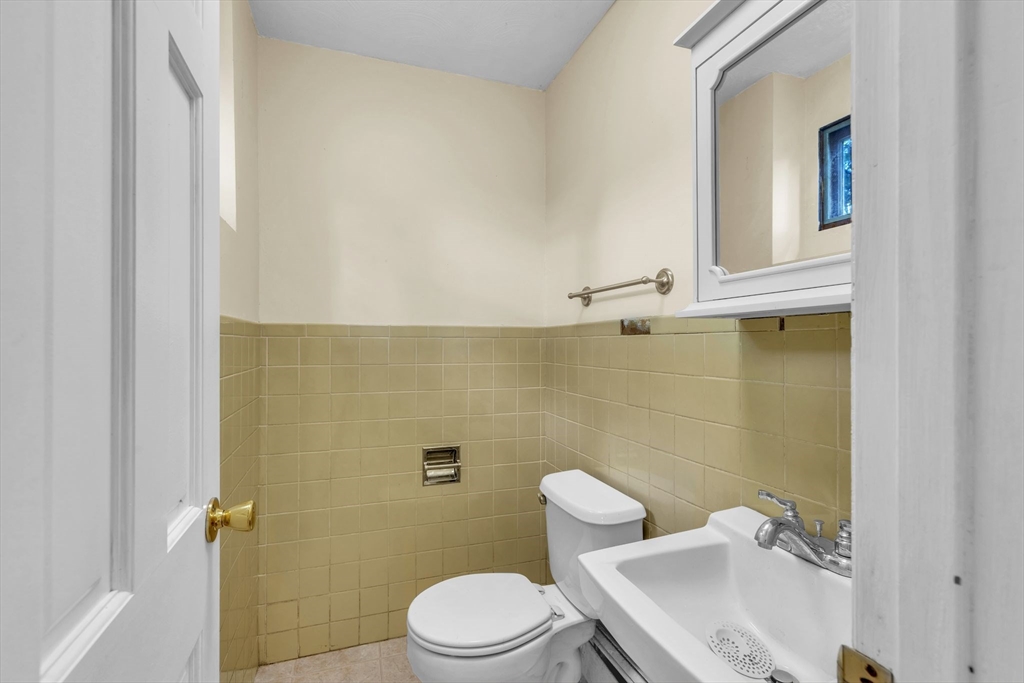 4 Birch Road Swampscott, MA 01907 - Photo 23 of 42 a white toilet sitting next to a bathroom sink