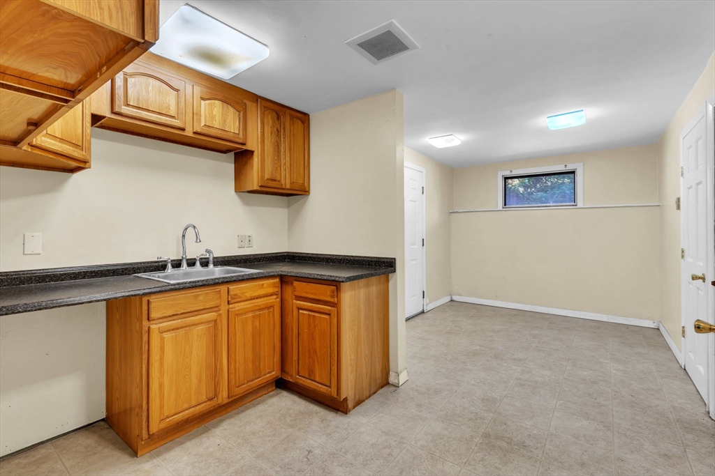 4 Birch Road Swampscott, MA 01907 - Photo 24 of 42 a kitchen with stainless steel appliances granite countertop a sink and a refrigerator