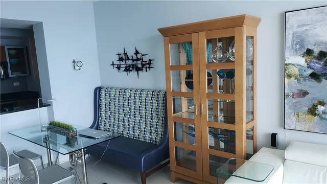 a living room with furniture and a painting on the wall