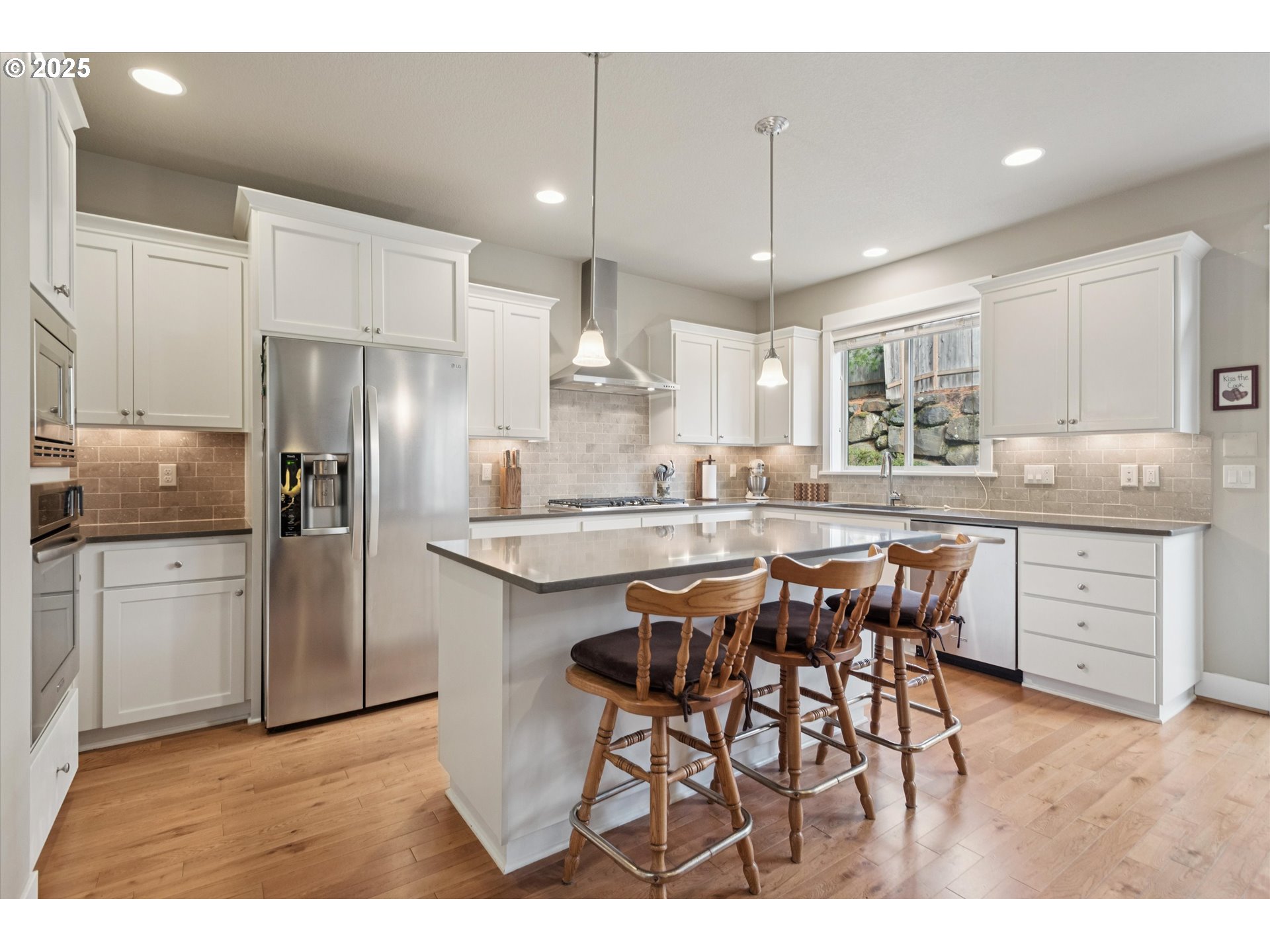 3041 Winkel Way West Linn, OR 97068 - Photo 12 of 45 a kitchen with stainless steel appliances kitchen island granite countertop a refrigerator and a stove top oven