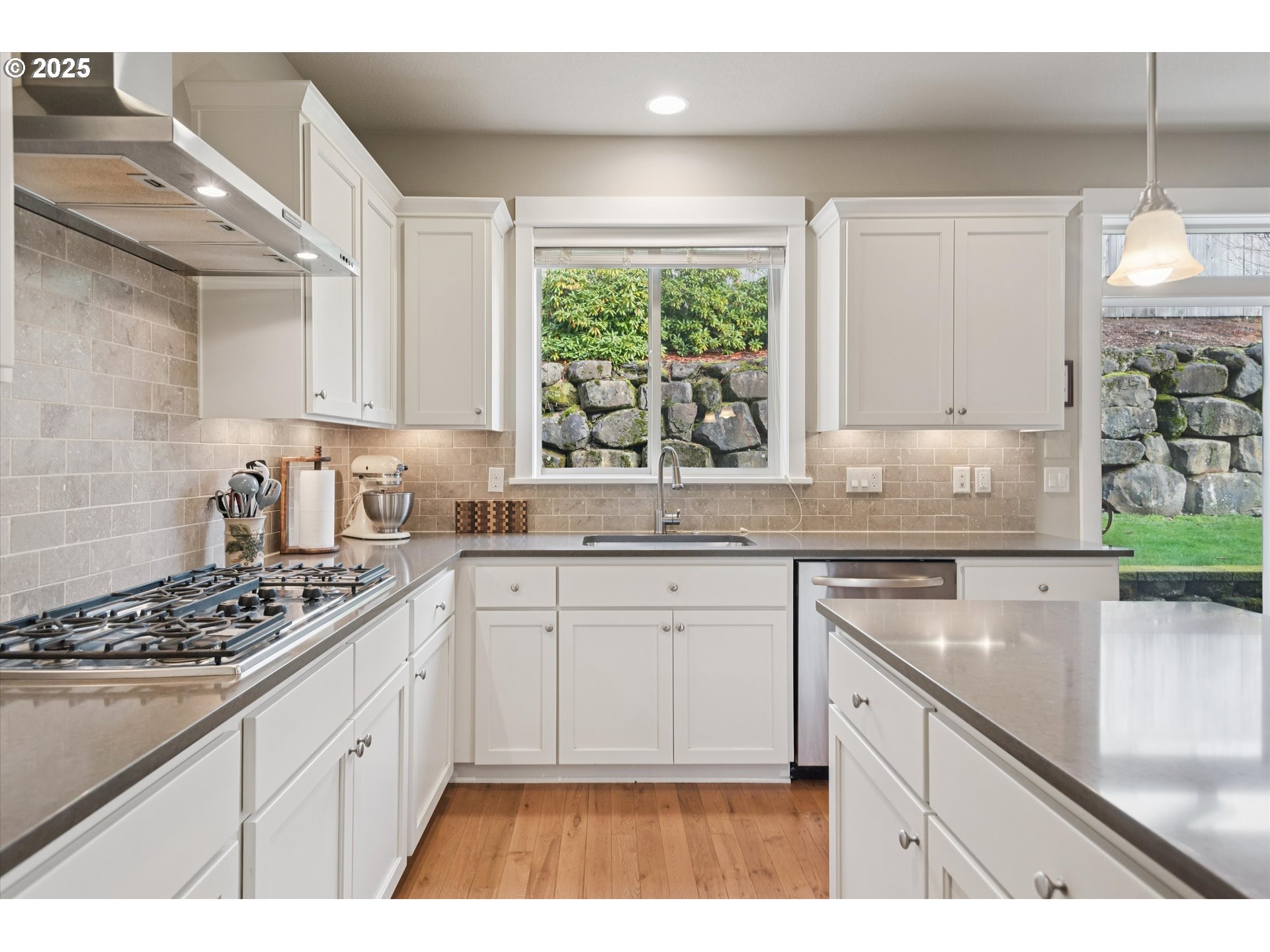 3041 Winkel Way West Linn, OR 97068 - Photo 15 of 45 a kitchen with stainless steel appliances granite countertop a stove a sink dishwasher and white cabinets with wooden floor
