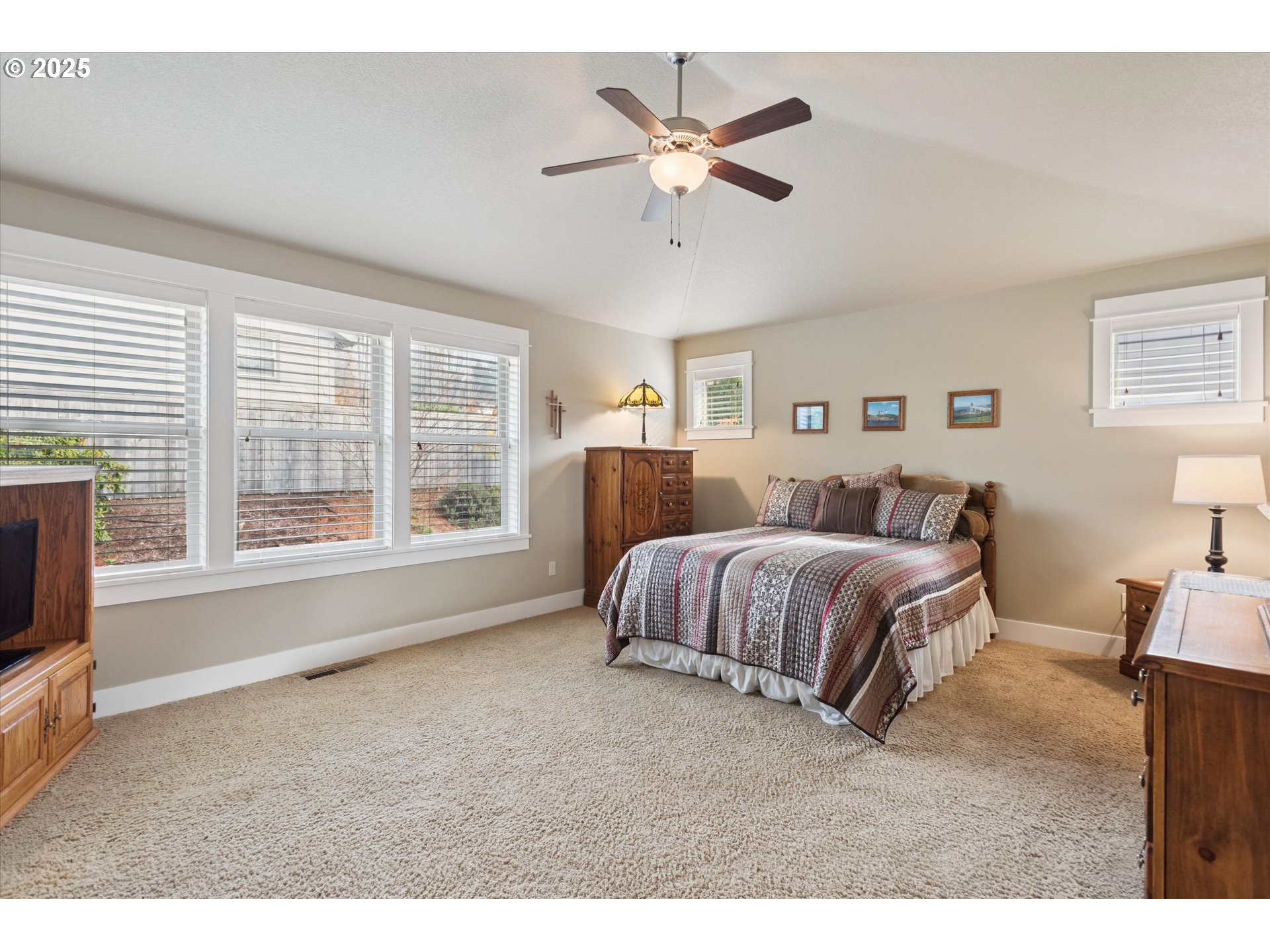 3041 Winkel Way West Linn, OR 97068 - Photo 20 of 45 a spacious bedroom with a bed a fireplace and a large window