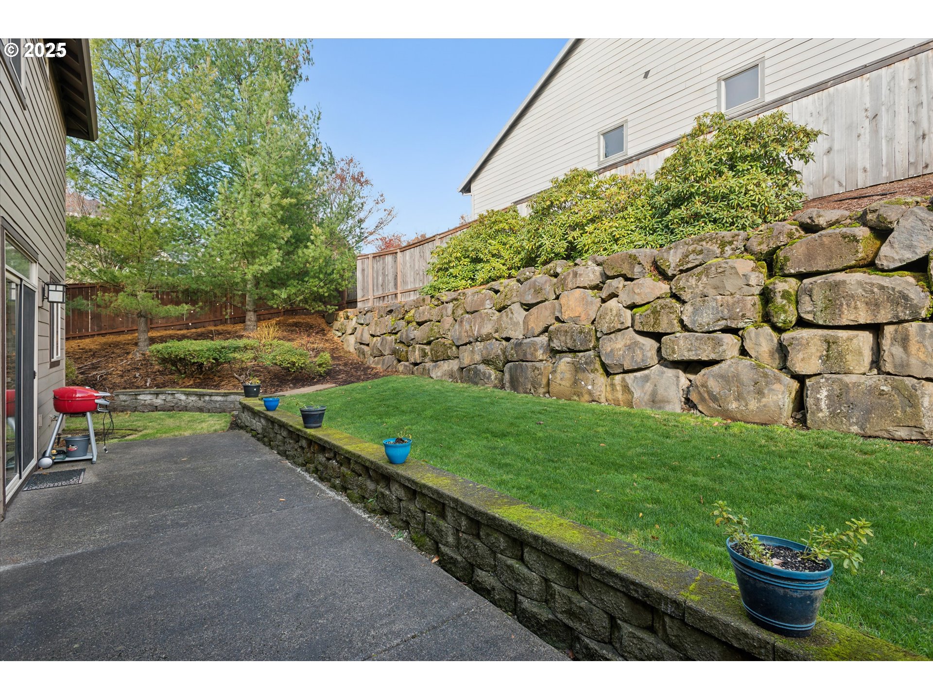 3041 Winkel Way West Linn, OR 97068 - Photo 37 of 45 a view of a backyard with plants and brick wall