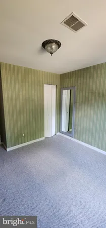 a view of a livingroom with a ceiling fan and window