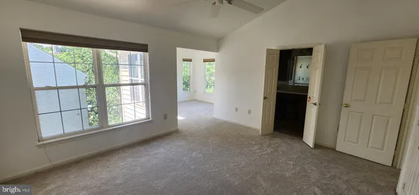 an empty room with windows and closet