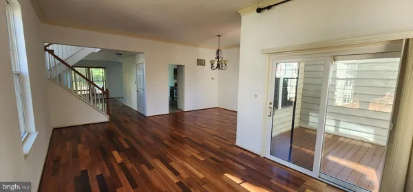 a view of a hallway view with wooden floor and staircase