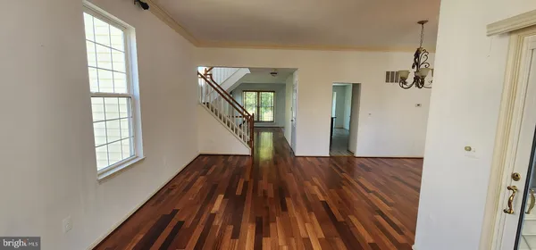 a view of entryway with wooden floor and stairs