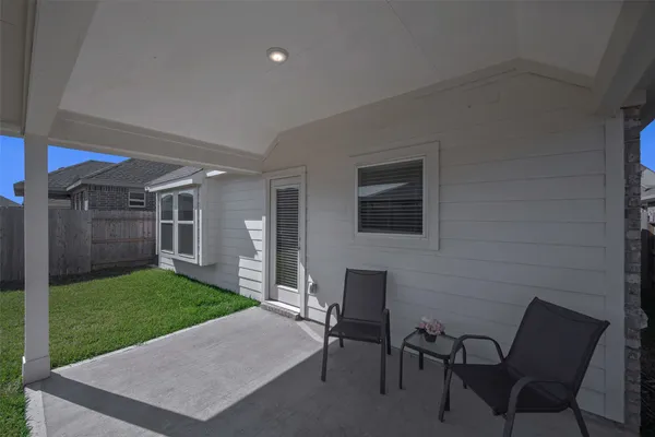 a view of a patio with a yard